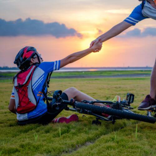 Increases feelings of compassion and empathy: An image of a person holding hands with someone else, an image of people helping each other