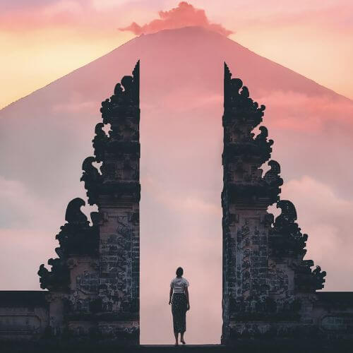 Opens the door to new opportunities and experiences: An image of a person standing at the door/gate