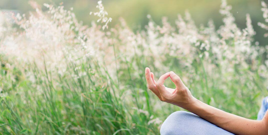 A person meditating in the nature.