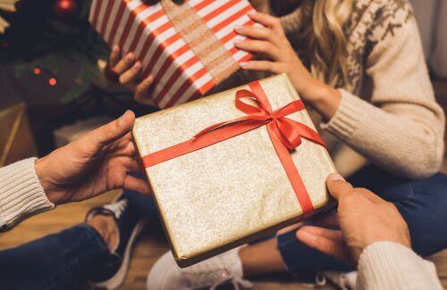 Two person exchanging gifts, representing generosity and abundance.