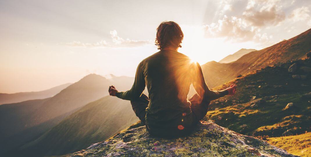 A people meditating in nature.