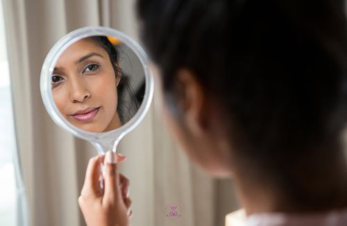 A mirror reflecting an image of a confident person.