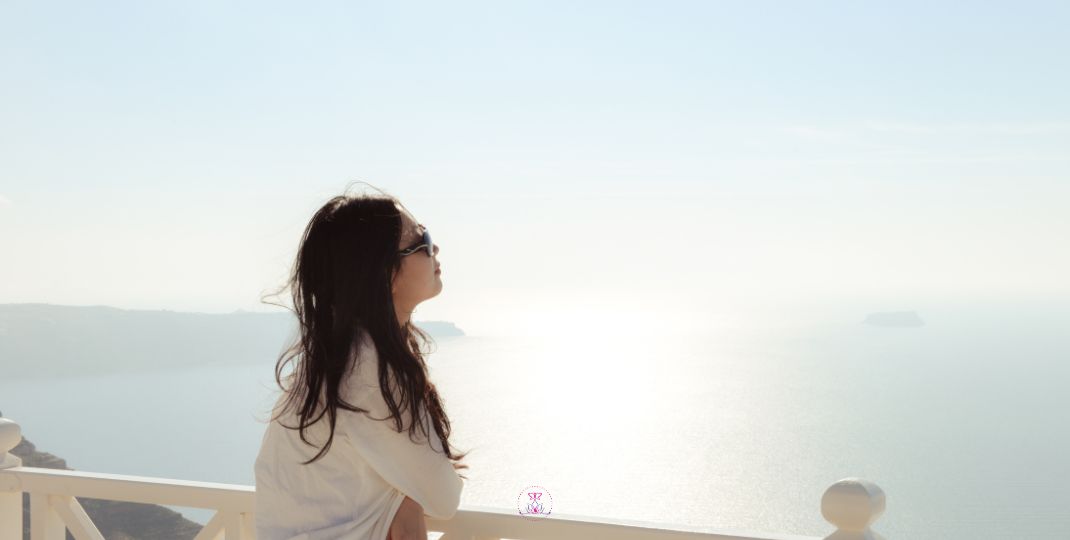 A silhouette watching the ocean horizon, looking out into a vast expanse, embodies the imagination of dreams.