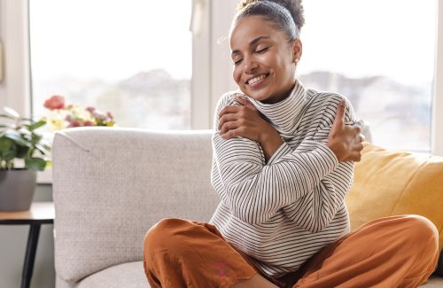 An illustration of a person hugging their inner child, symbolizing self-love and healing.