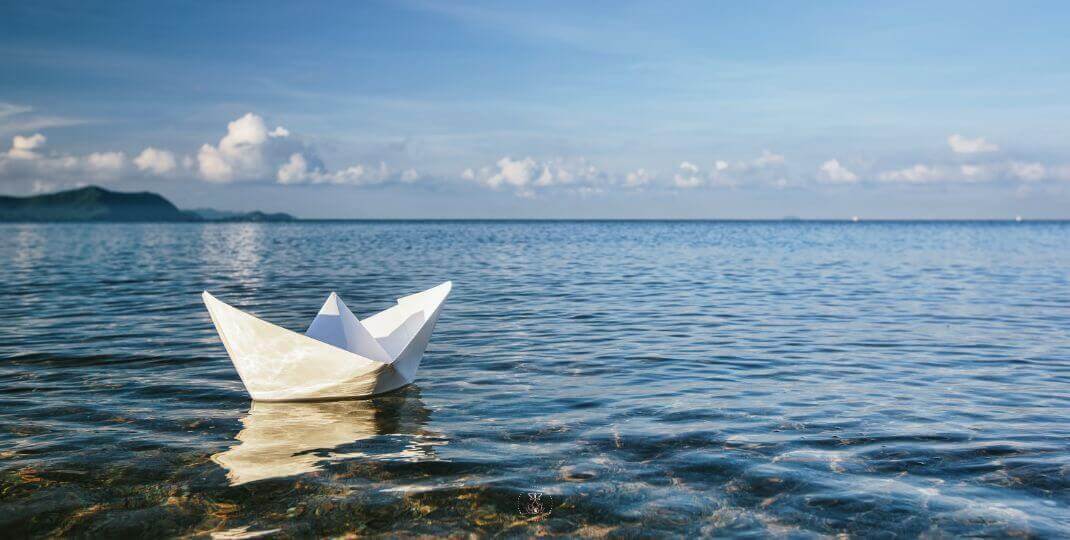 Released paper boat in a river, it symbolizes our emotions as they come and go.