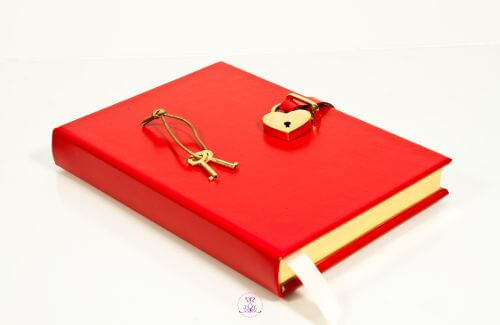 A closed journal with a heart-shaped lock and key.