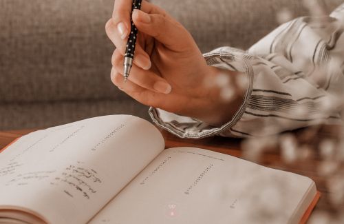 A person checking tasks on a calendar.