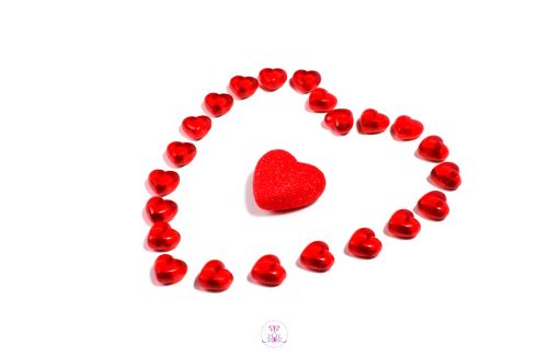 Image symbolizing the power of love - hearts protect a heart