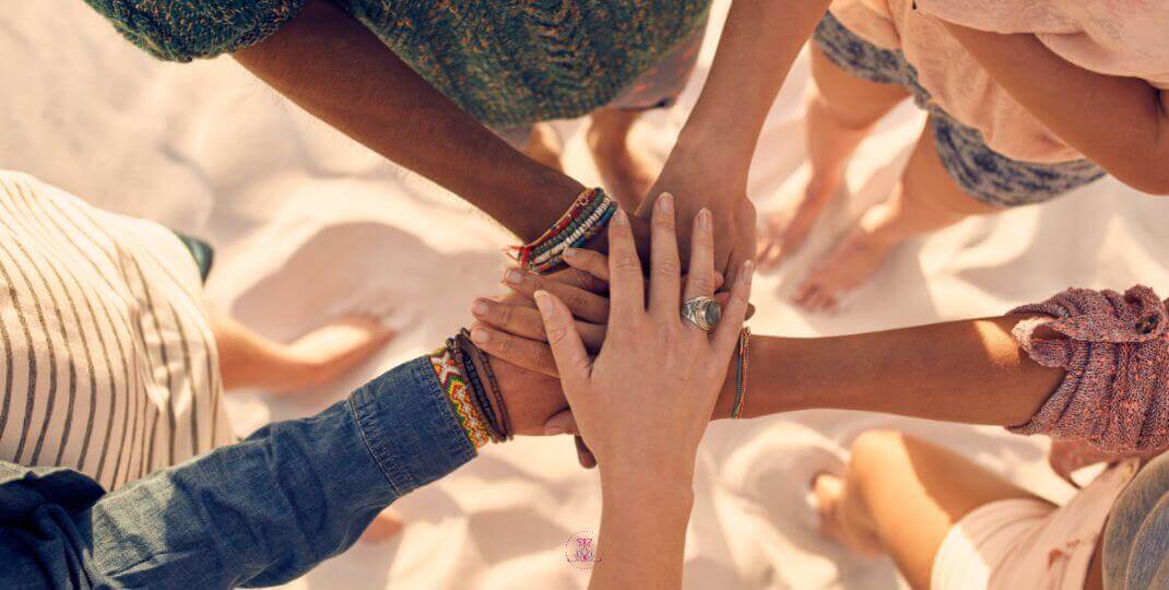 An image of diverse individuals holding hands in unity.