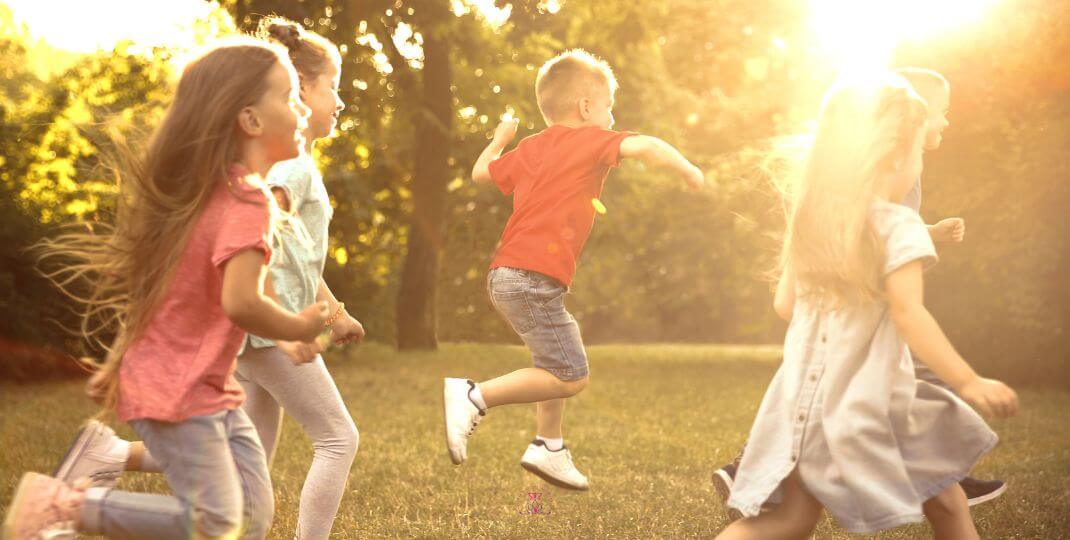 A group of children laughing and playing in a sunlit meadow, evoking the joy of rediscovery