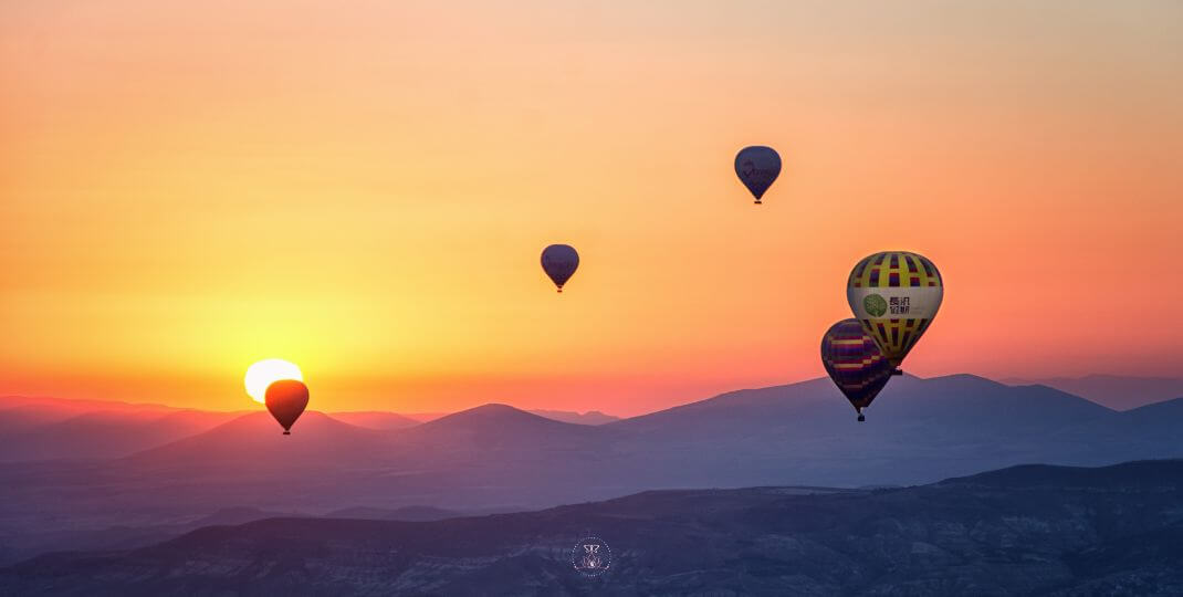 Balloons floating against a clear sky, symbolizing the lightness of being.