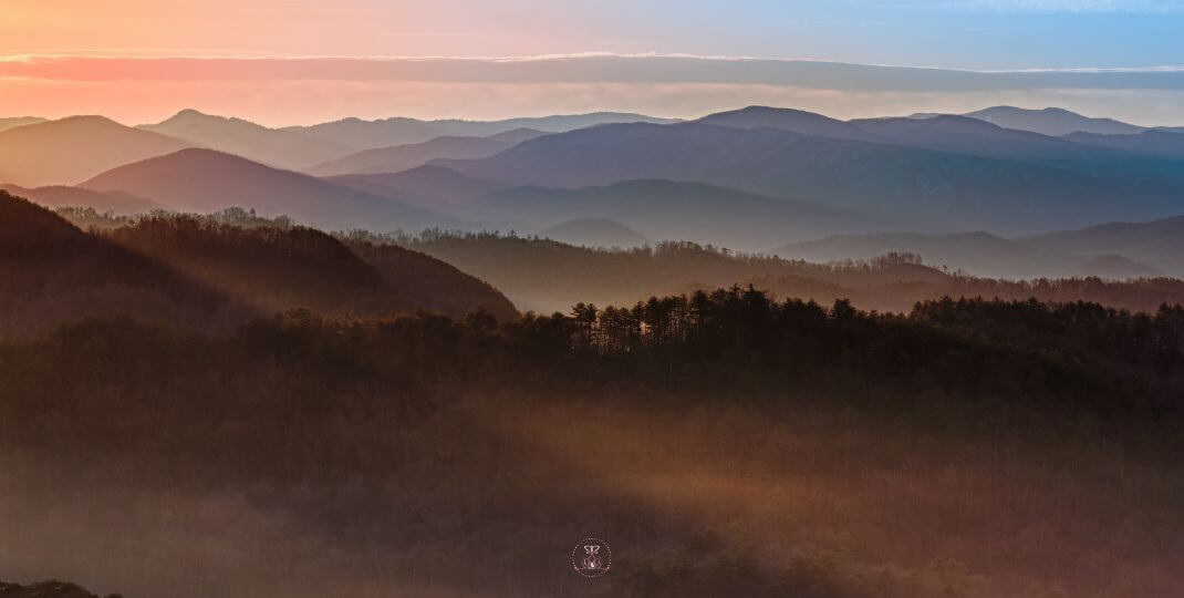 A sunrise over a tranquil mountain landscape