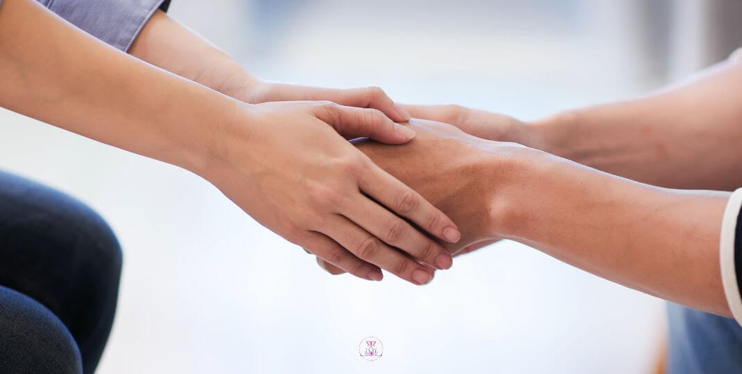 Being Present for Someone - A close-up of two hands holding, representing compassion and support.