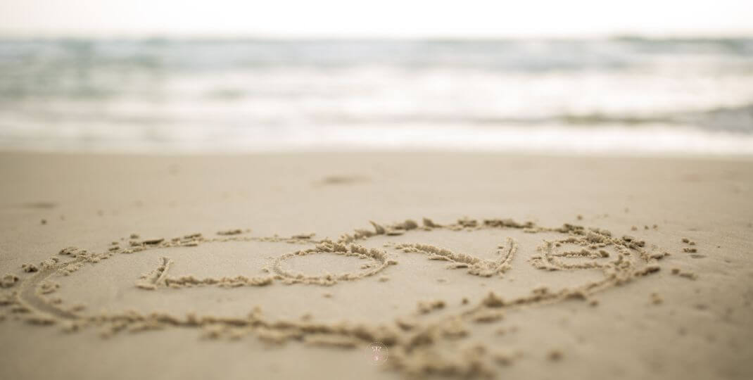 Finding Happiness Within - Heart Shape Drawn in Sand on a Beach with Gentle Waves