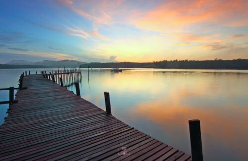 Releasing What No Longer Serves You - Image of a calm, serene body of water reflecting the sky