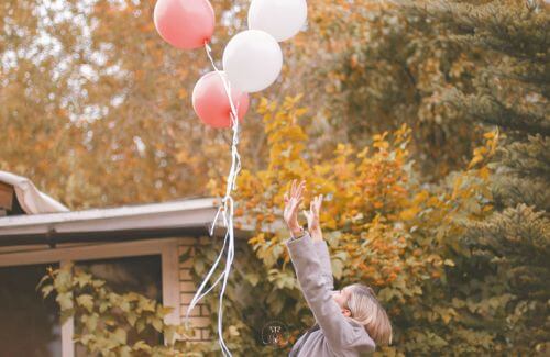 Releasing What No Longer Serves You - Image of a hand releasing a balloon into the sky