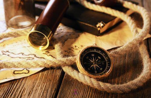 Finding Your True Path - Compass and Map on a Wooden Table