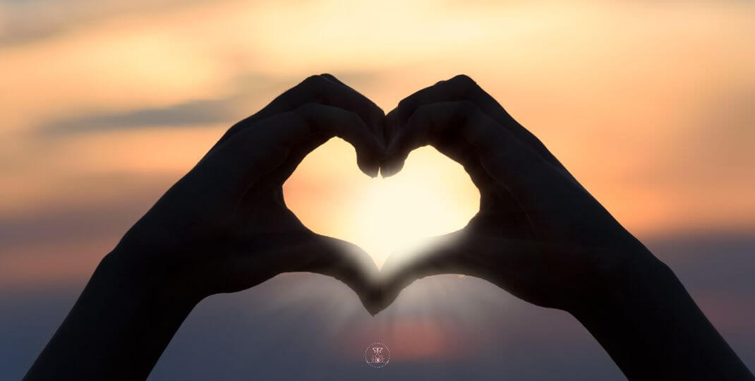 Practices for Healing Self-Judgment - Close-up of hands forming a heart shape against the sun