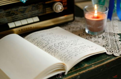 Power of Pausing for Inner Peace - A journal and pen with soft candlelight