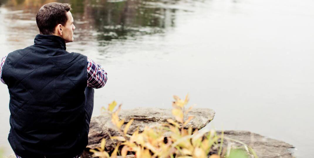 Power of Pausing for Inner Peace - A peaceful nature scene with a person sitting in stillness